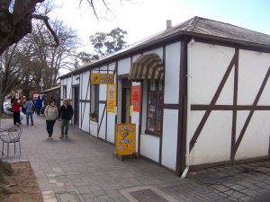 View of a lolly shop in the Adelaide Hills with a couple walking past